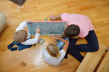 Image showing family drawing on school board at home