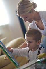 Image showing family drawing on school board at home