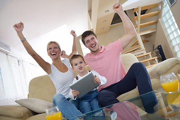 Image showing family at home using tablet computer