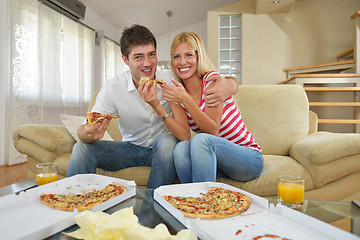 Image showing couple at home eating  pizza