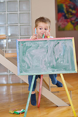 Image showing family drawing on school board at home