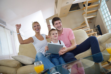 Image showing family at home using tablet computer
