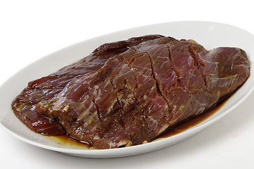 Image showing Marinaded flank steak on a plate