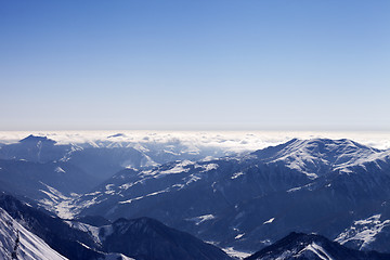 Image showing View from off-piste slope on snowy mountains in haze