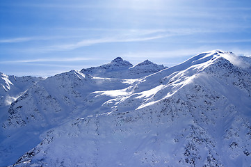 Image showing Snowy sunlight mountains, view from off piste slope