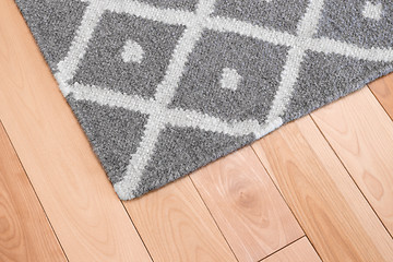 Image showing Gray rug on wooden floor