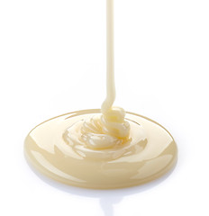 Image showing pouring condensed milk on a white background