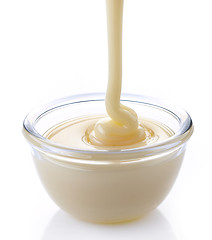 Image showing pouring condensed milk with sugar in a bowl