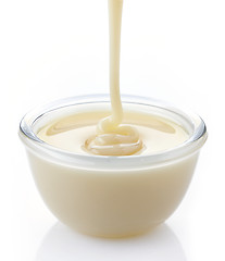 Image showing pouring condensed milk with sugar in a bowl