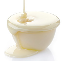 Image showing pouring condensed milk with sugar in a bowl