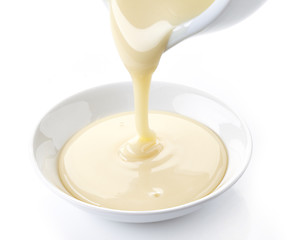 Image showing pouring condensed milk with sugar in a bowl