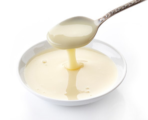 Image showing pouring condensed milk with sugar in a bowl