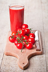 Image showing tomato juice in glass and fresh tomatoes 