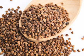 Image showing Buckwheat seeds on wooden spoon in closeup 