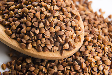 Image showing Buckwheat seeds on wooden spoon in closeup 