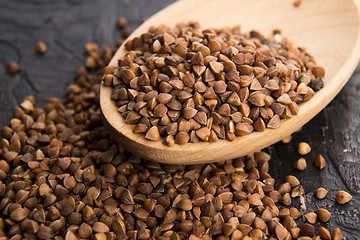 Image showing Buckwheat seeds on wooden spoon in closeup 