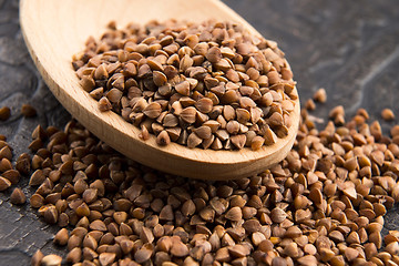 Image showing Buckwheat seeds on wooden spoon in closeup 