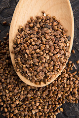 Image showing Buckwheat seeds on wooden spoon in closeup 