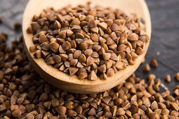 Image showing Buckwheat seeds on wooden spoon in closeup 