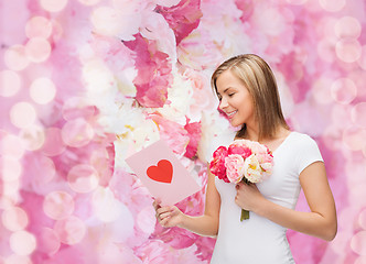 Image showing smiling girl with postcard and bouquet of flowers