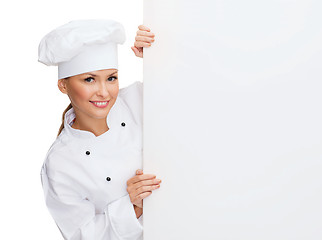 Image showing smiling female chef with white blank board