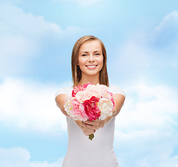 Image showing smiling woman with bouquet of flowers