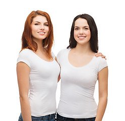 Image showing two laughing girls in white t-shirts hugging