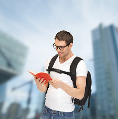Image showing student in eyeglasses with backpack and book