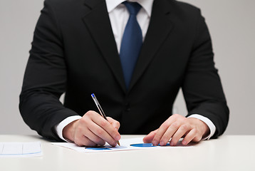 Image showing close up of businessman with papers