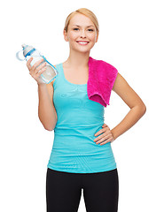 Image showing sporty woman with towel and watel bottle