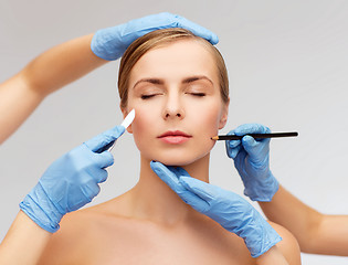 Image showing woman face and beautician hands with pencil