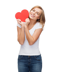 Image showing smiling woman in white t-shirt with heart