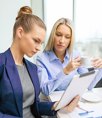 Image showing business team with tablet pc having discussion