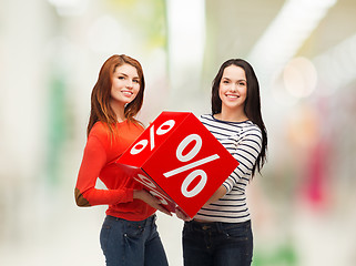 Image showing two smiling teenage girl with percent sign on box