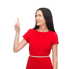 Image showing young woman in red dress pointing her finger