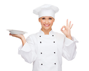 Image showing female chef with empty plate showing ok sign