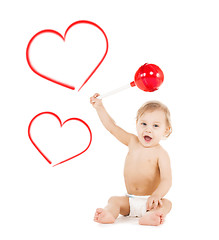 Image showing cute little boy playing with big lollipop