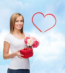 Image showing smiling woman with bouquet of flowers and gift box