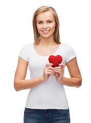 Image showing smiling woman in white t-shirt with heart