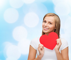 Image showing smiling woman in white t-shirt with heart