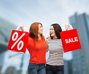 Image showing two smiling teenage girl with shopping bags