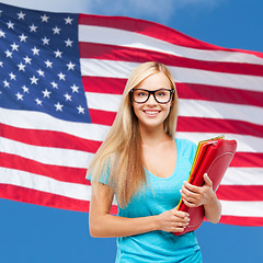 Image showing smiling student in eyeglasses with folders