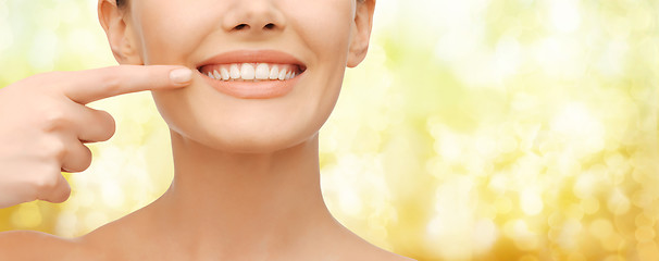 Image showing beautiful woman pointing to teeth