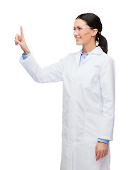 Image showing smiling female doctor pointing to something