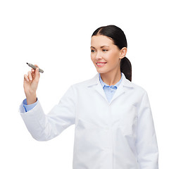 Image showing female doctor working with something imaginary