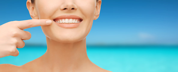 Image showing beautiful woman pointing to teeth