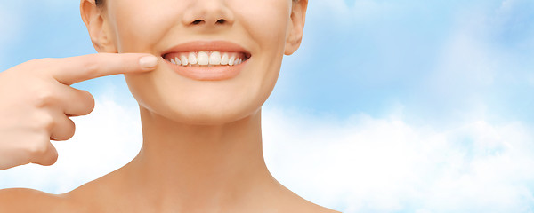 Image showing beautiful woman pointing to teeth