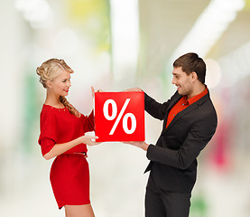 Image showing smiling woman and man with red percent sale sign