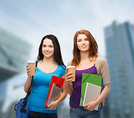 Image showing two students with bag, folders, tablet and coffee