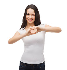 Image showing smiling girl showing heart with hands